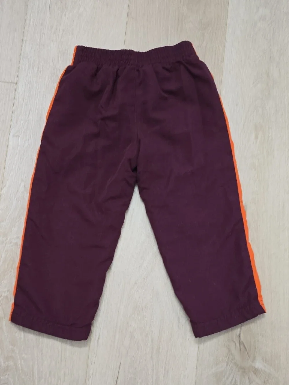 Nike Kids Burgundy Pants with Orange Side Stripes